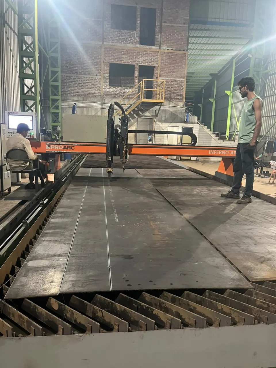 CNC plasma cutting machine operator at the table